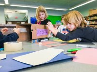 Students making a prototype for a penguin nesting box as part of a maker project