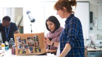 Photo of teacher and student looking at portfolio