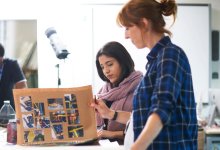 Photo of teacher and student looking at portfolio