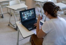 Teacher leading a virtual lesson in her empty classroom