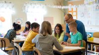 Photo of elementary school teacher and students in classroom