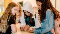 HIgh school students using their smart phones at school