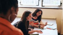 Teachers meeting in classroom