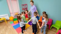 Photo of elementary students and teacher in a circle