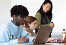 Photo of middle school students on laptops in classroom