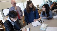 Photo of middle school students working on math in classroom