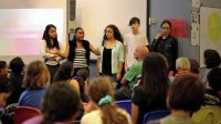 A group of students are having a presentation in front of the classroom.