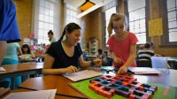 Students are working on a board game and puzzle game.