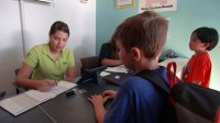 Students deposite money to bankers at their school.