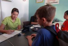 Students deposite money to bankers at their school.