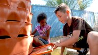 Students are planting in the school backyard.