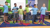 A group of students are having fun in a classroom.