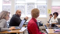 Teachers meeting in a classroom