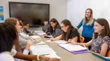 Teacher working with high school students 