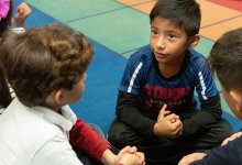 Students in elementary class talk in pairs and small groups. 