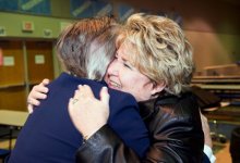 Two women hugging each other