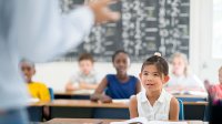 photo of young students sitting at desks in a classroom