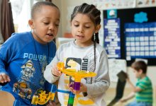 Two kindergartners working on a marble project in class