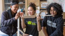 Students assemble a model wind turbine they constructed. 