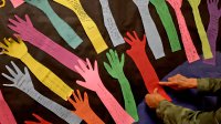 Elementary school teacher working on hallway bulletin board