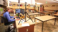 Science teacher Geoff Reilly teaches an online class from his empty classroom