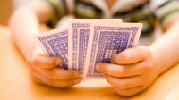 photo of playing cards in child's hands