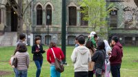 Prospective university students listening to a tour guide during a campus tour