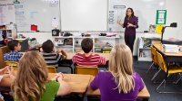 Teacher speaking to middle school class.