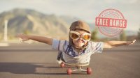 Photo of a boy lying on a skateboard pretending he's flying.