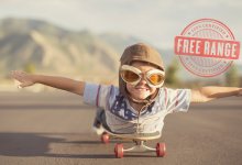 Photo of a boy lying on a skateboard pretending he's flying.