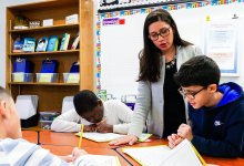 Teacher helping students with project