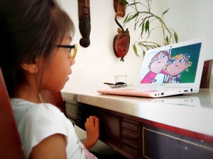 Young girl engaged in programming on a laptop