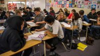 A classroom of high school students working in small groups