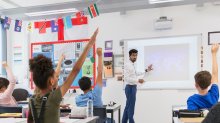 Teacher leading classroom via projector screen