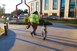 A father and his daughter walk outside of Educare.