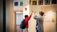 Teacher and student high-fiving