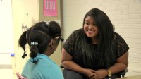 Madisen Steele, Trauma-Informed Practitioner, talking with an elementary school student