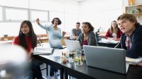 High school students listen to a lecture in a science classroom