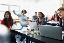 High school students listen to a lecture in a science classroom