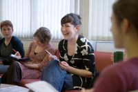 Teacher laughing during a staff meeting