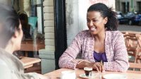 Two educators take time to relax over a cup of coffee. 