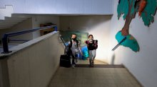 Israeli pupils wearing protective gear make their way to their classroom upon return to school after the COVID-19 lockdown, at Hashalom elementary in Mevaseret Zion, in the suburbs of Jerusalem, on May 3, 2020.