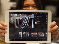 photo of a student holding a tablet computer