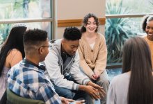 A group of teen students sitting in a classroom discussion circle