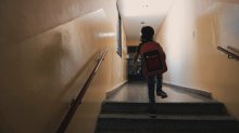 Photo of child running up the stairs in school