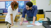 Kareem helping a student.