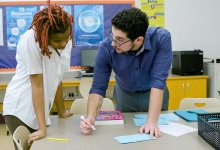 Kareem helping a student.