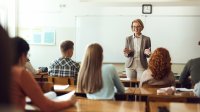 Teacher talking in front of high school class