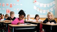 Elementary students writing at their desks