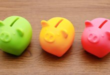 Three brightly-colored piggy banks